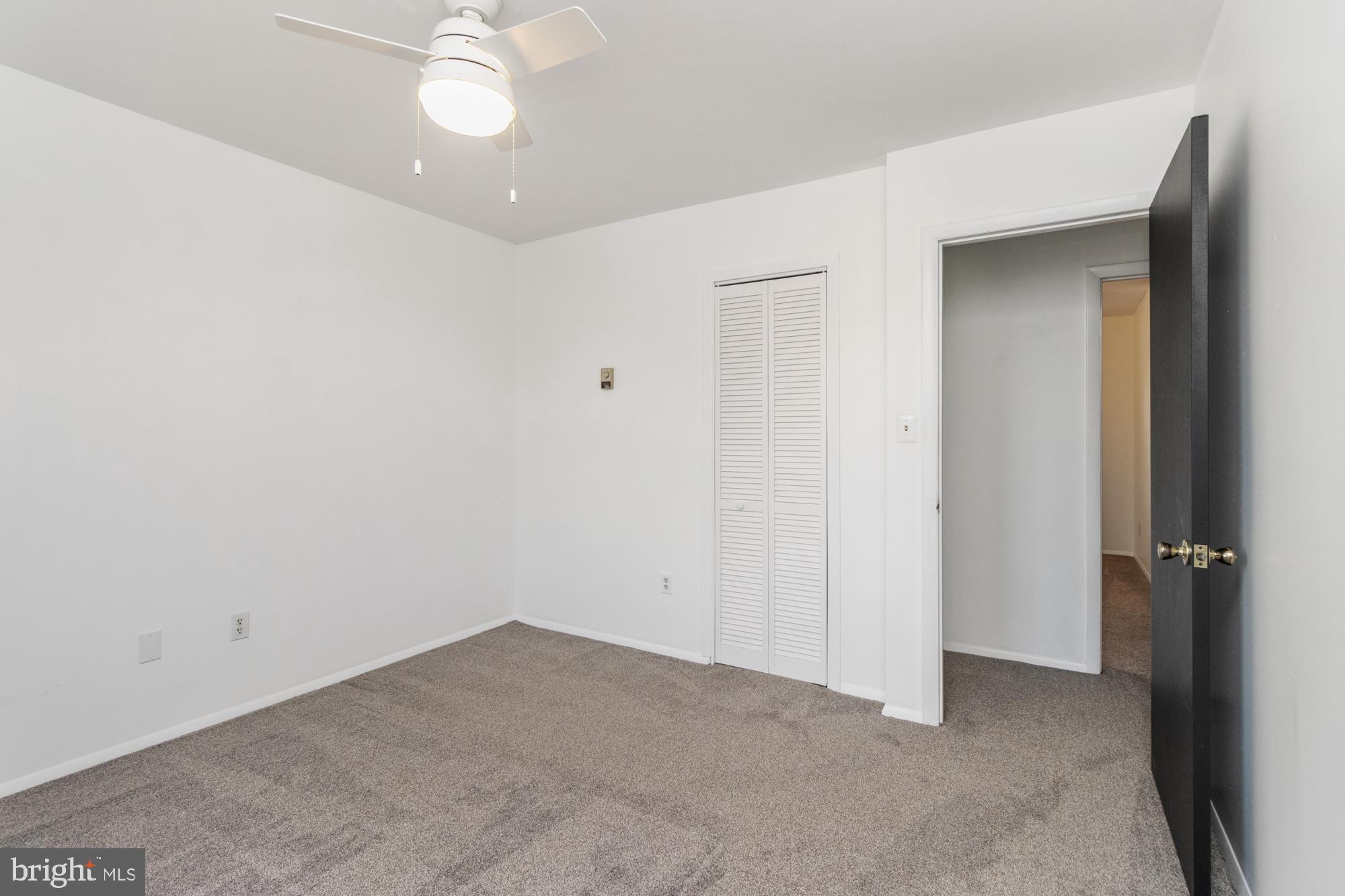3135 Sollers Point Road Baltimore, MD 21222 - Photo 27 of 36 an empty room with a ceiling fan and a window