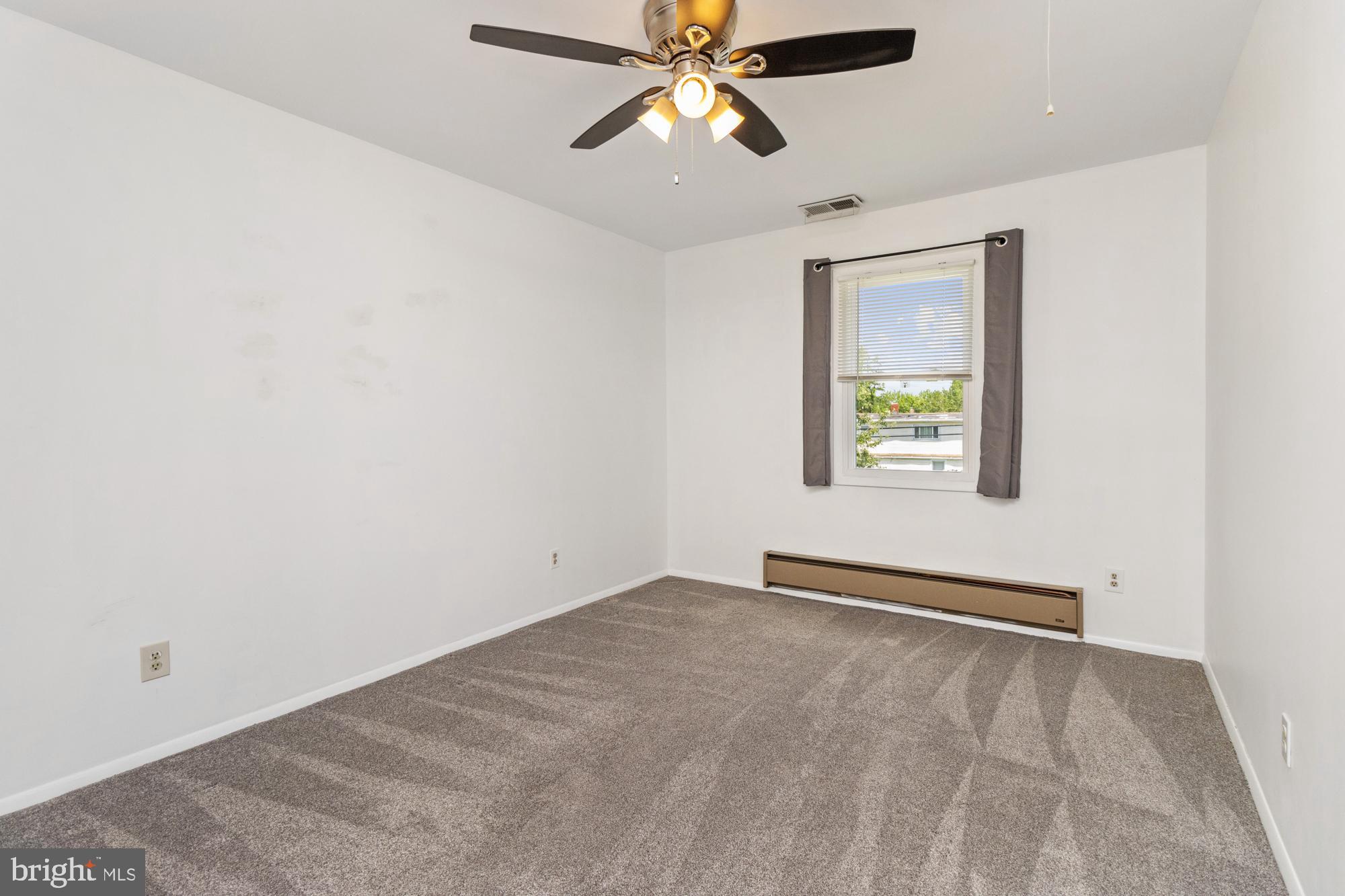 3135 Sollers Point Road Baltimore, MD 21222 - Photo 29 of 36 an empty room with windows and fan