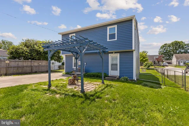 a backyard of a house with table and chairs