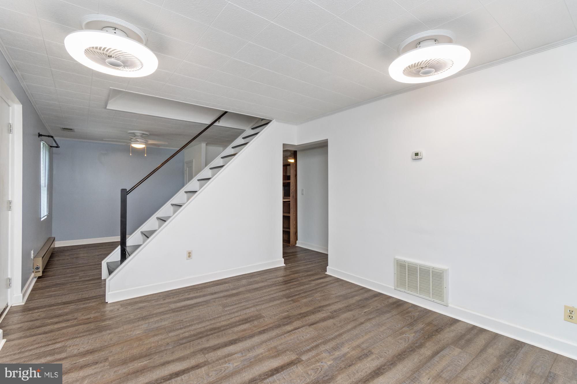 3135 Sollers Point Road Baltimore, MD 21222 - Photo 6 of 36 a view of an empty room with wooden floor