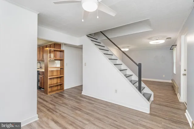 a view of a livingroom with wooden floor and staircase