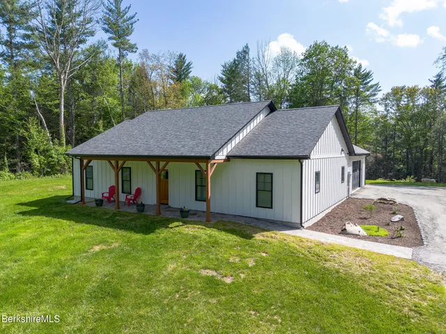 a view of a house with a yard and tree s