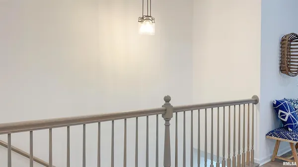 a view of a hallway with wooden floor and a window
