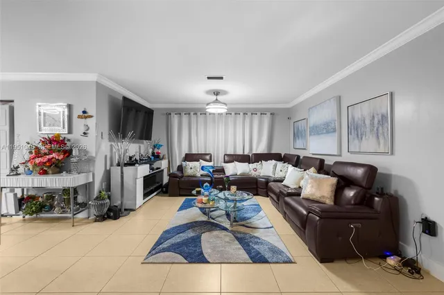 a view of a dining room with furniture and a chandelier