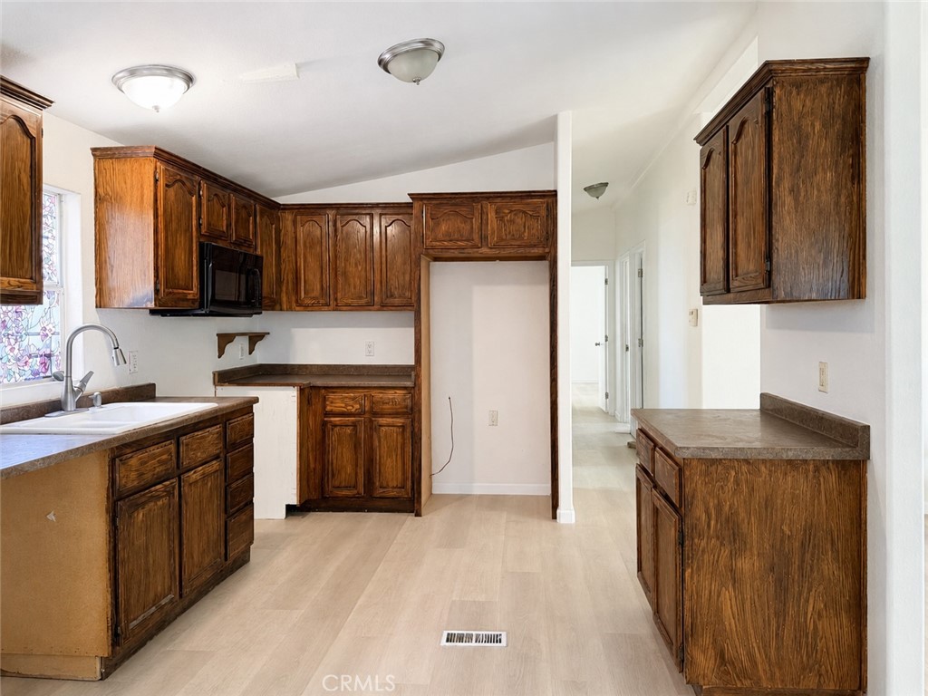 3067 Carl Street Riverside, CA 92507 - Photo 6 of 23 Bright, functional kitchen featuring extensive cabinetry and ample storage space.