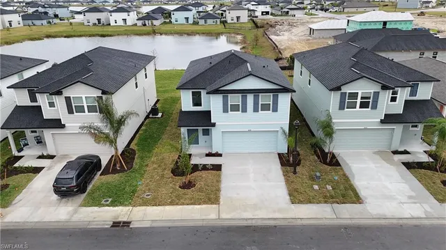 an aerial view of a house with swimming pool and ocean view