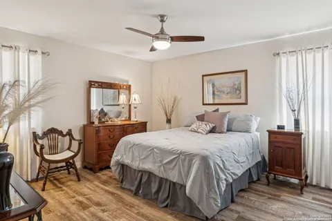 a bedroom with a bed and wooden floor