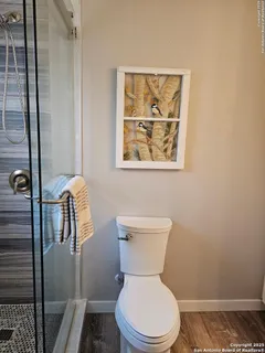 a white toilet sitting next to a bathroom sink