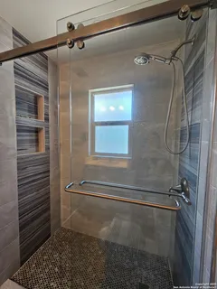 a bathroom with a shower and a sink