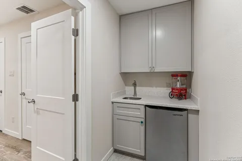a kitchen with stainless steel appliances granite countertop white cabinets and white refrigerator