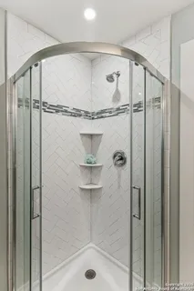 a bathroom with a glass shower door