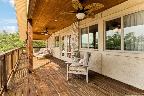 a balcony with furniture and large windows