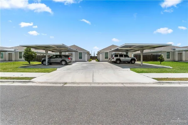 a view of building with cars parked in front of it