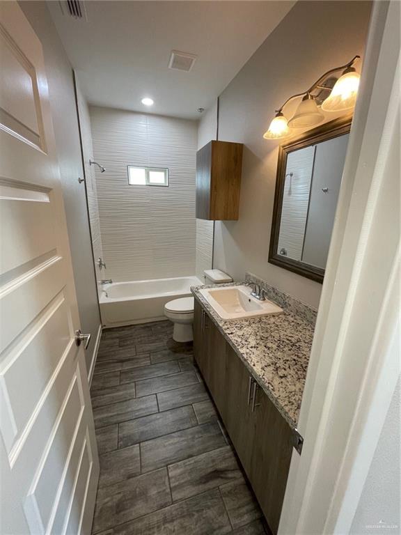 912 Kentucky Street Alton, TX 78573 - Photo 16 of 21 a bathroom with a granite countertop sink and a mirror