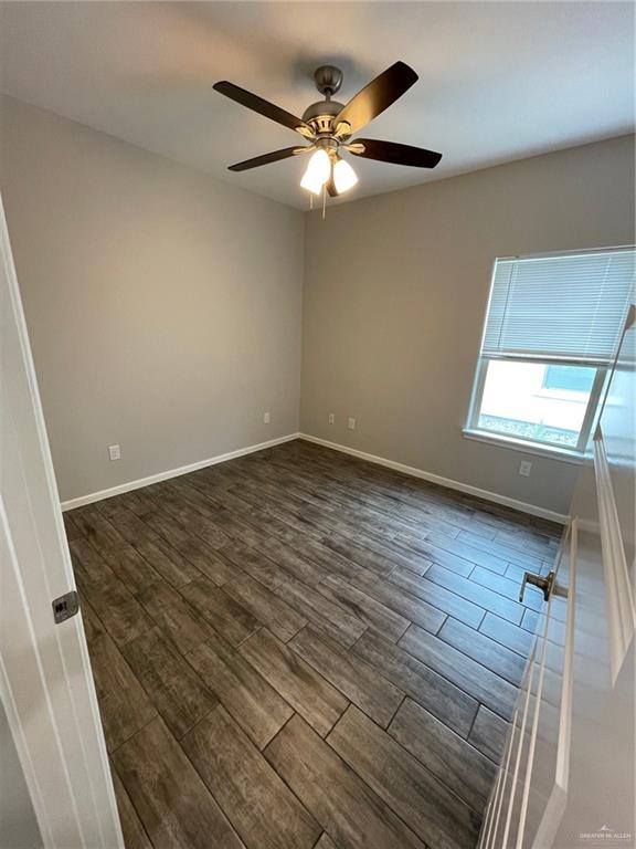 912 Kentucky Street Alton, TX 78573 - Photo 17 of 21 an empty room with wooden floor fan and windows