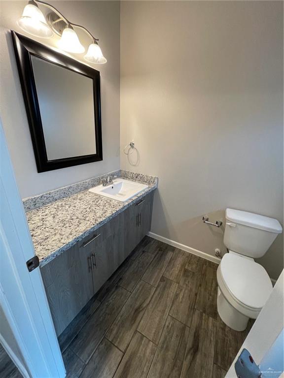 912 Kentucky Street Alton, TX 78573 - Photo 19 of 21 a bathroom with a granite countertop toilet sink and mirror