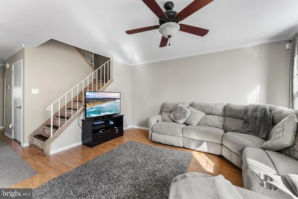 a living room with furniture and a chandelier