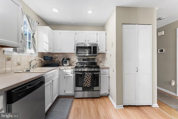 a kitchen with a sink and a stove top oven