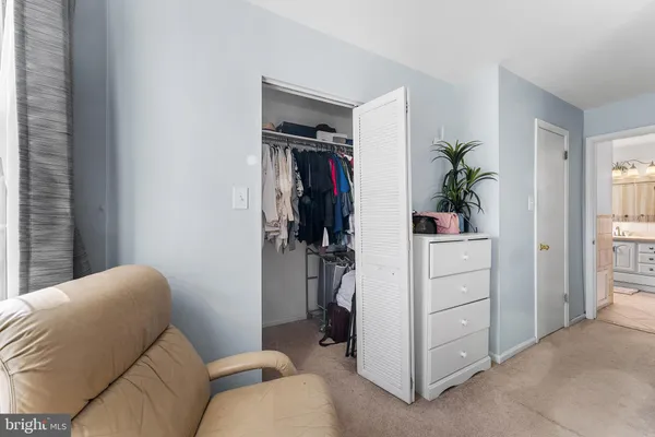 a living room with furniture and a closet