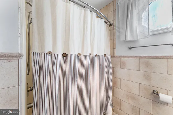 a view of a bathroom with a shower curtain