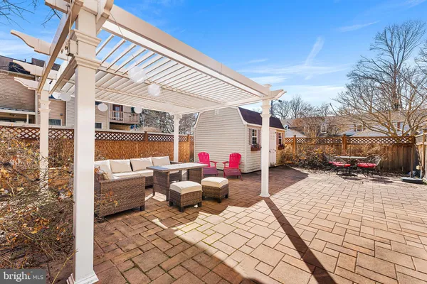 a view of a patio with a table and chairs and potted plants