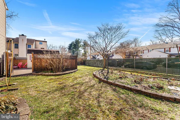 a view of a backyard with snow on the road