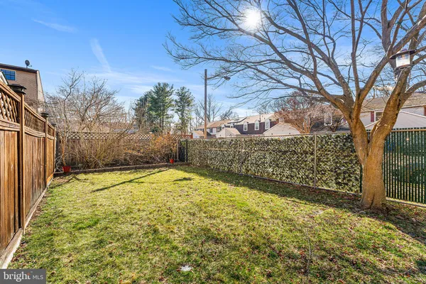 a view of a yard with wooden fence