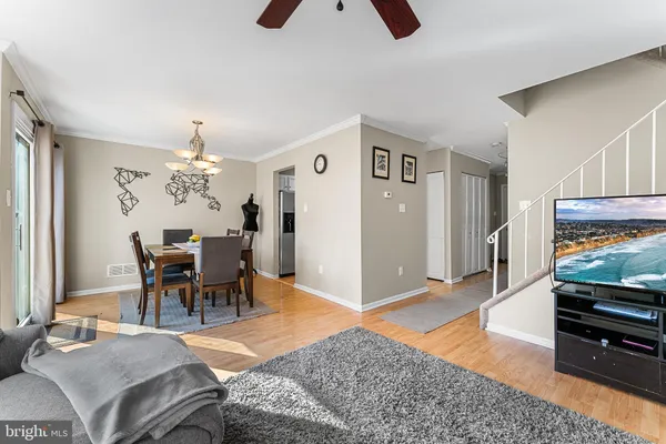 a living room with furniture a dining table and a piano