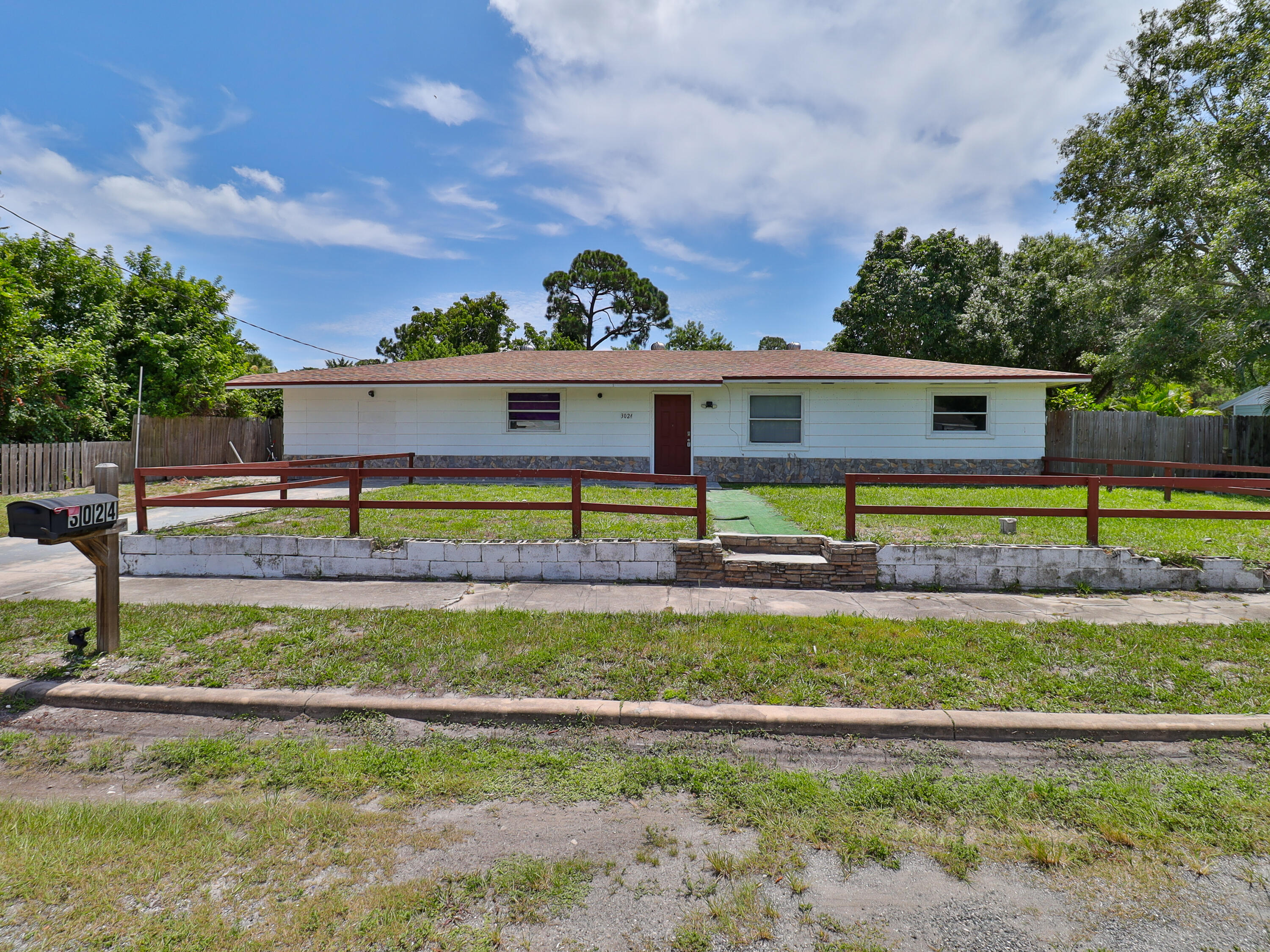 3024 West Dixie Boulevard Fort Pierce, FL 34946 - Photo 1 of 26 a front view of a house with a yard