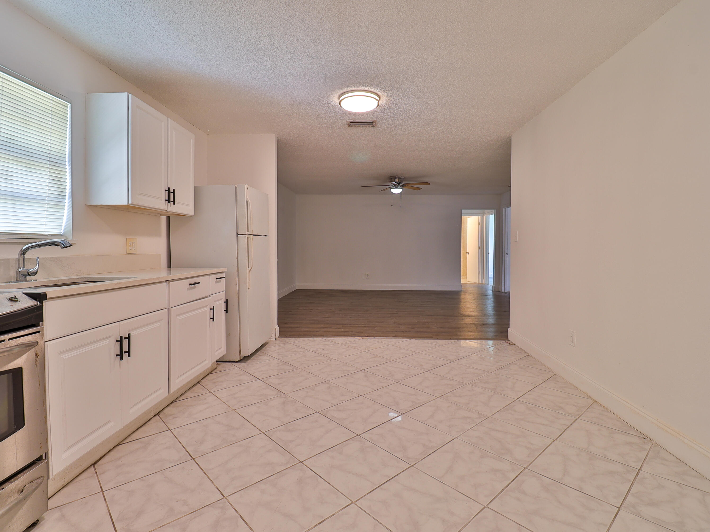 3024 West Dixie Boulevard Fort Pierce, FL 34946 - Photo 16 of 26 a view of a kitchen with white cabinets