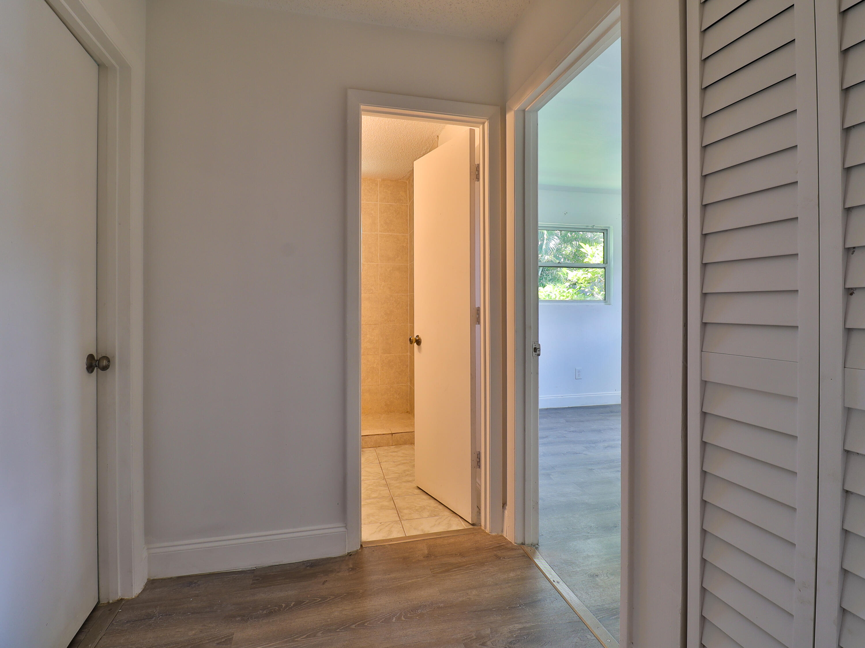 3024 West Dixie Boulevard Fort Pierce, FL 34946 - Photo 21 of 26 an empty room with wooden floor and a window