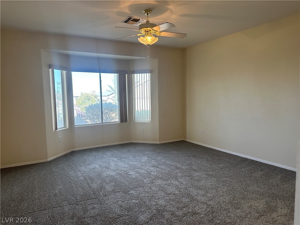3034 Canal Walk Road Henderson, NV 89052 - Photo 9 of 24 This airy bedroom features large bay windows and plush carpeting for comfort and light.