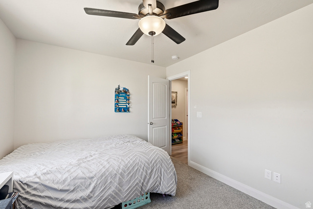 668 East Fiddlers Canyon Road, Unit 6 Cedar City, UT 84721 - Photo 21 of 36 Room featuring a ceiling fan with integrated lighting, neutral wall paint, and gray carpet flooring