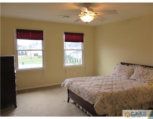 8 Keppel Road Plainsboro, NJ 08536 - Photo 20 of 22 a bedroom with a bed chandelier and a window