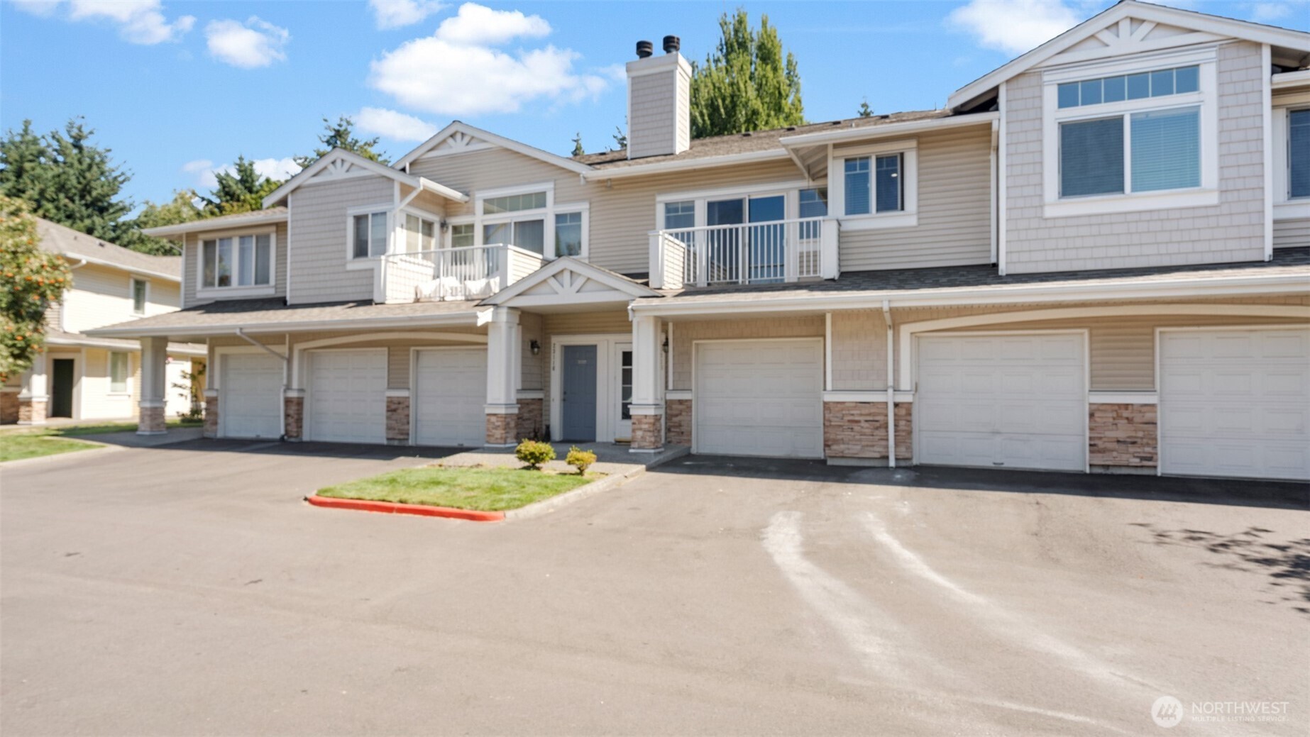 23118 59th Place South, Unit 154 Kent, WA 98032 - Photo 21 of 25 a front view of a house with a yard and garage