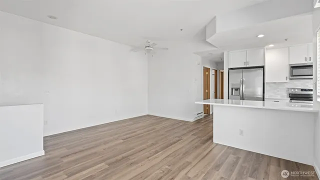 a view of kitchen with wooden floor electronic appliances and window