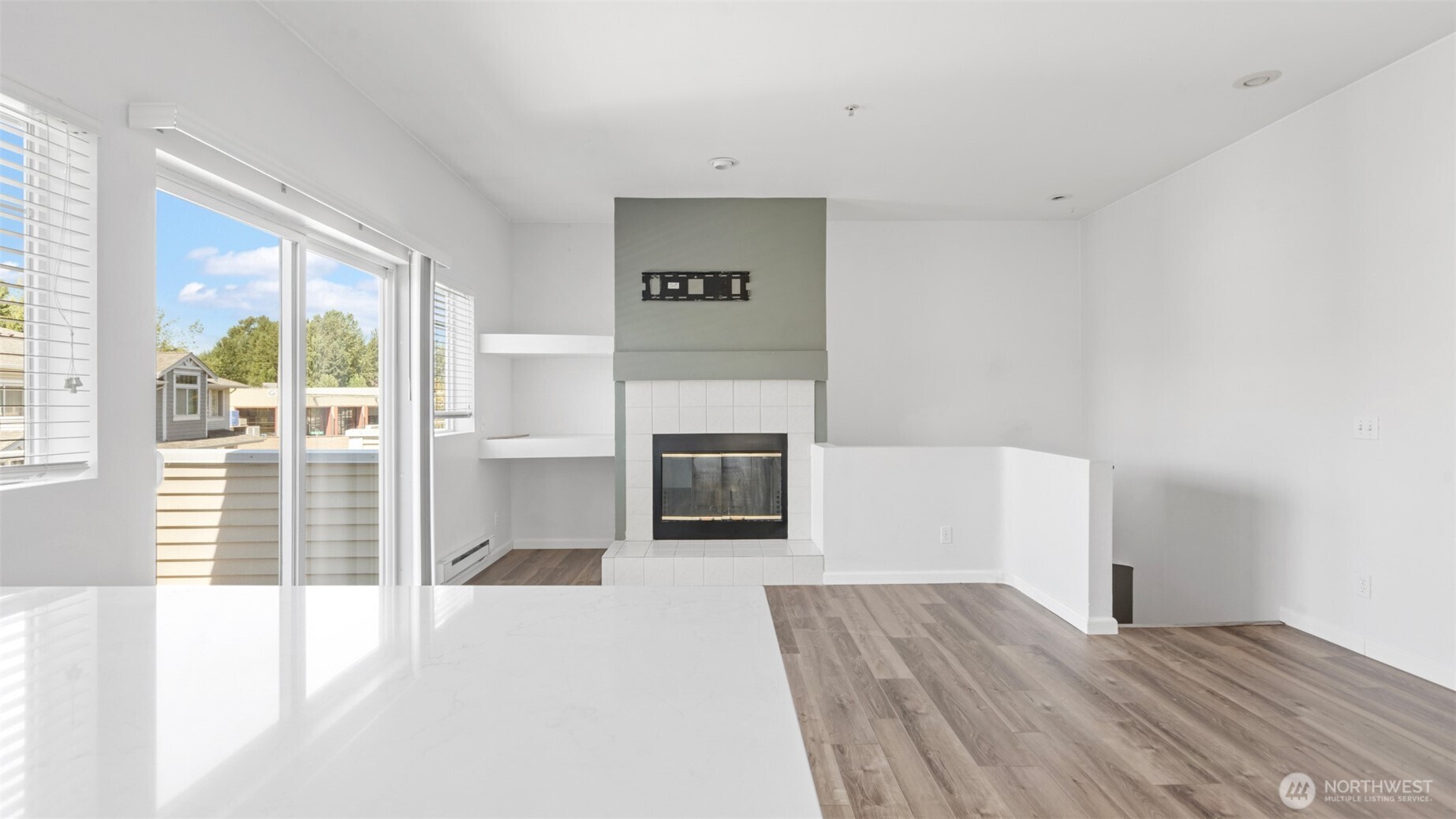 23118 59th Place South, Unit 154 Kent, WA 98032 - Photo 9 of 25 a view of a livingroom with wooden floor and a fireplace