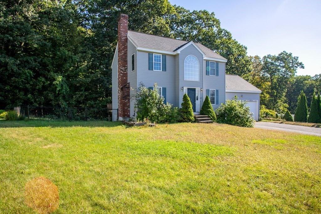 a view of a house with pool and garden