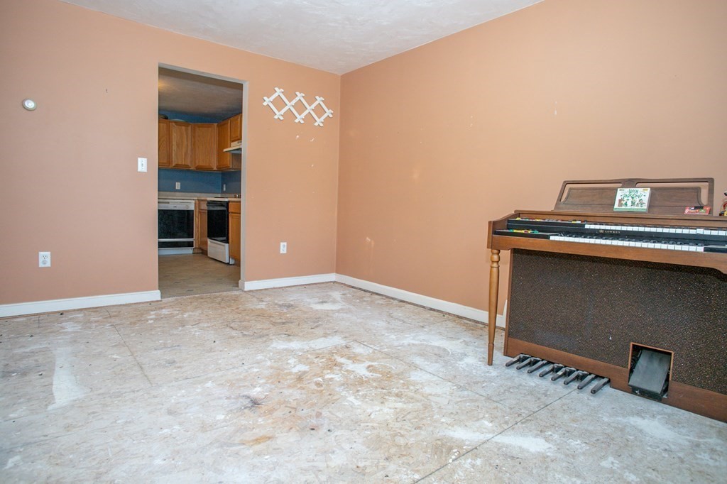 64 Bishop Road Fitchburg, MA 01420 - Photo 11 of 40 an empty room with a fireplace and painted walls