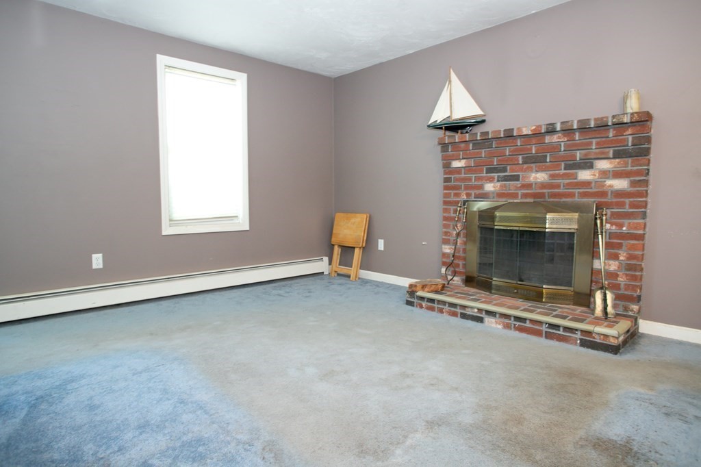 64 Bishop Road Fitchburg, MA 01420 - Photo 16 of 40 an empty room with a fireplace and window