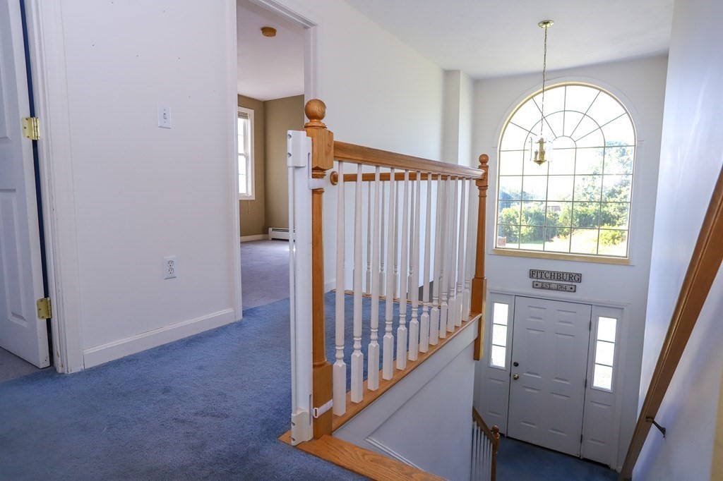 64 Bishop Road Fitchburg, MA 01420 - Photo 24 of 40 an empty room with wooden floor windows and entryway