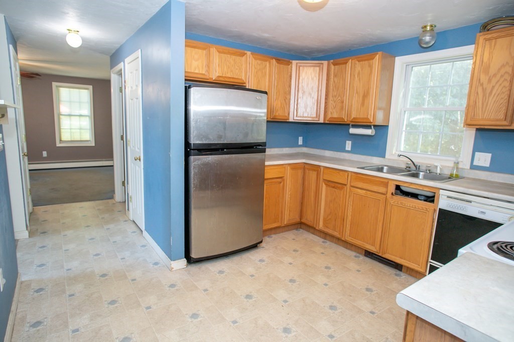 64 Bishop Road Fitchburg, MA 01420 - Photo 5 of 40 a kitchen with stainless steel appliances a refrigerator sink and cabinets