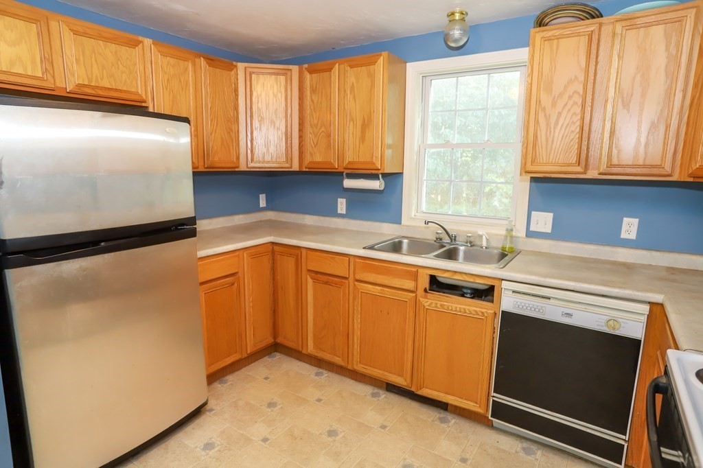 64 Bishop Road Fitchburg, MA 01420 - Photo 6 of 40 a kitchen with granite countertop cabinets stainless steel appliances a sink and window