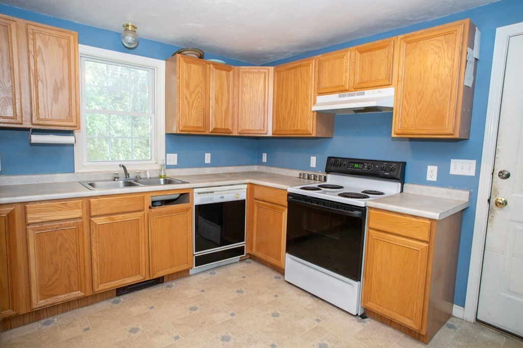 64 Bishop Road Fitchburg, MA 01420 - Photo 7 of 40 a kitchen with stainless steel appliances granite countertop a sink stove and cabinets