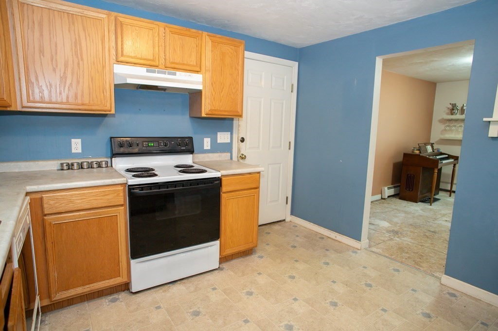 64 Bishop Road Fitchburg, MA 01420 - Photo 8 of 40 a kitchen with a stove and a microwave