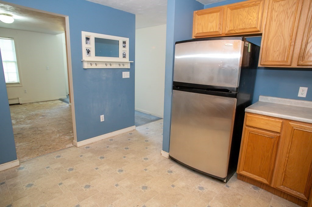 64 Bishop Road Fitchburg, MA 01420 - Photo 9 of 40 a view of a refrigerator in kitchen and a cabinets