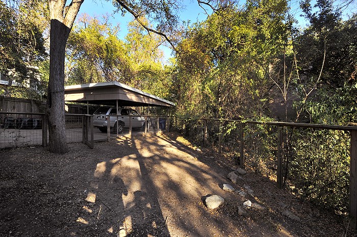 2819 San Gabriel Street, Unit A Austin, TX 78705 - Photo 21 of 21 a view of a table and chairs under an umbrella