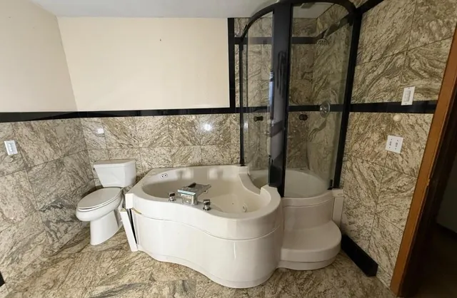 a white bath tub sitting in a bathroom