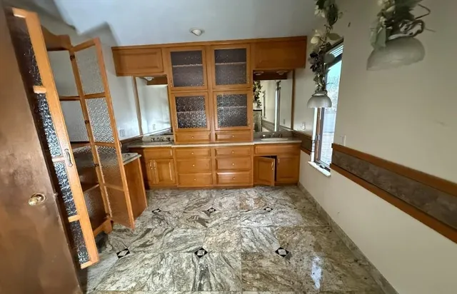 a view of kitchen with wooden floor and electronic appliances