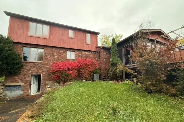 a backyard of a house with table and chairs